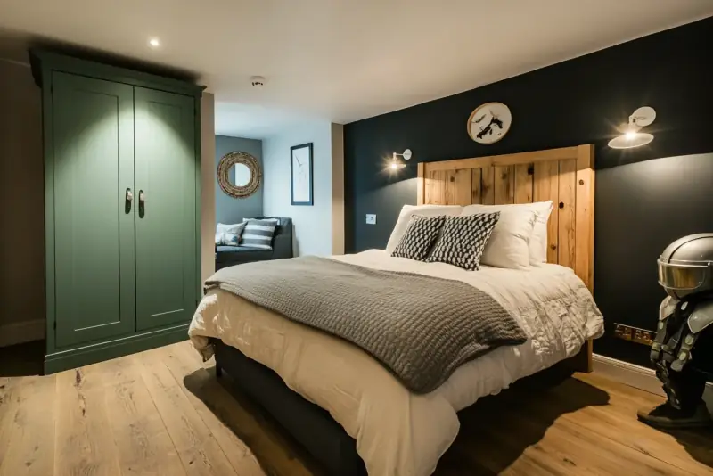 Bedroom with fitted green wardrobes.