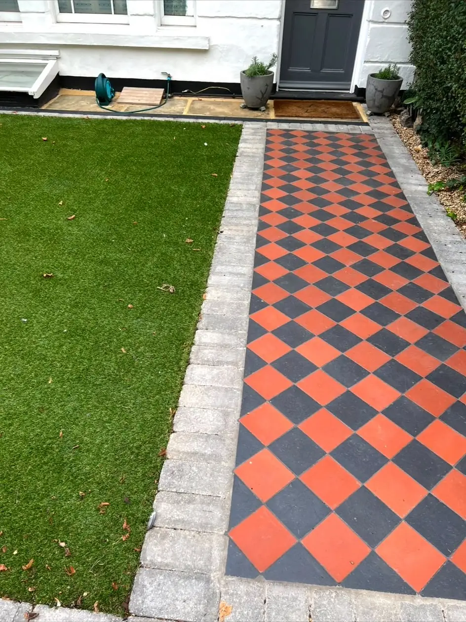 A red and black chequerboard tiled front path with granite sett edging, running from the pavement to the front door.