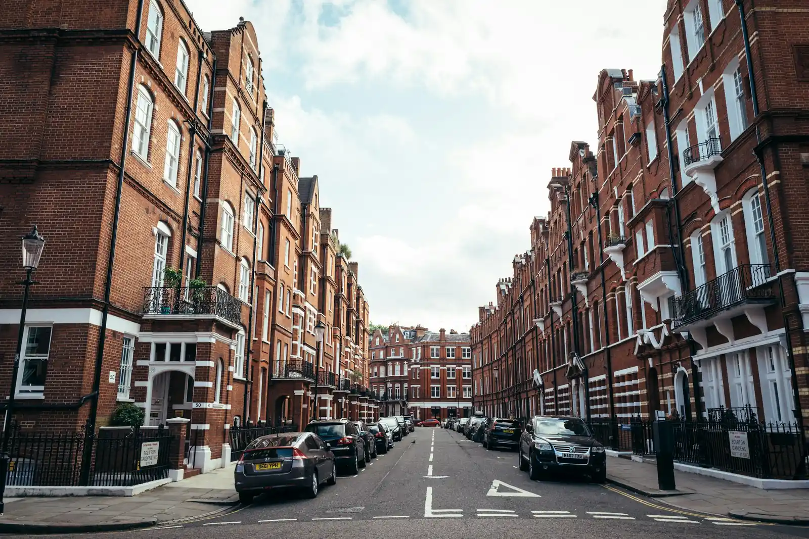 A street of red brick terraced housing.