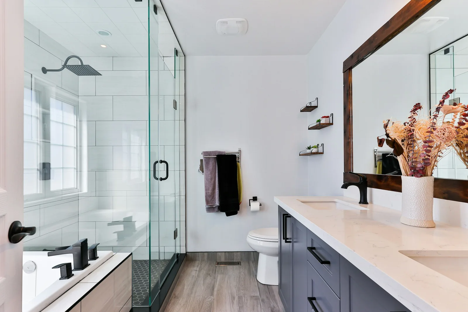 A plain modern bathroom with a shower and a vanity unit.