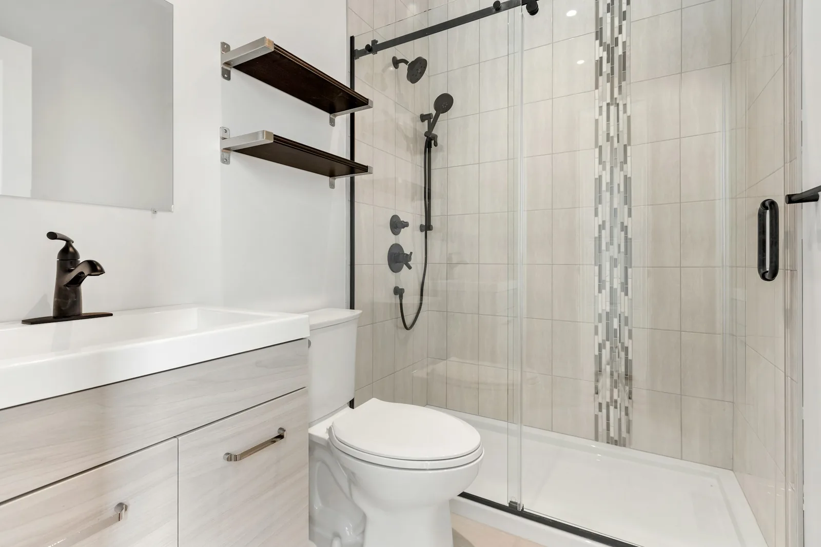 A tidy bathroom with a shower unit and toilet.