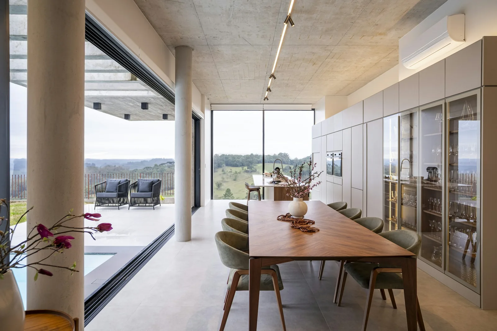 A dining room with full-height windows onto a garden.
