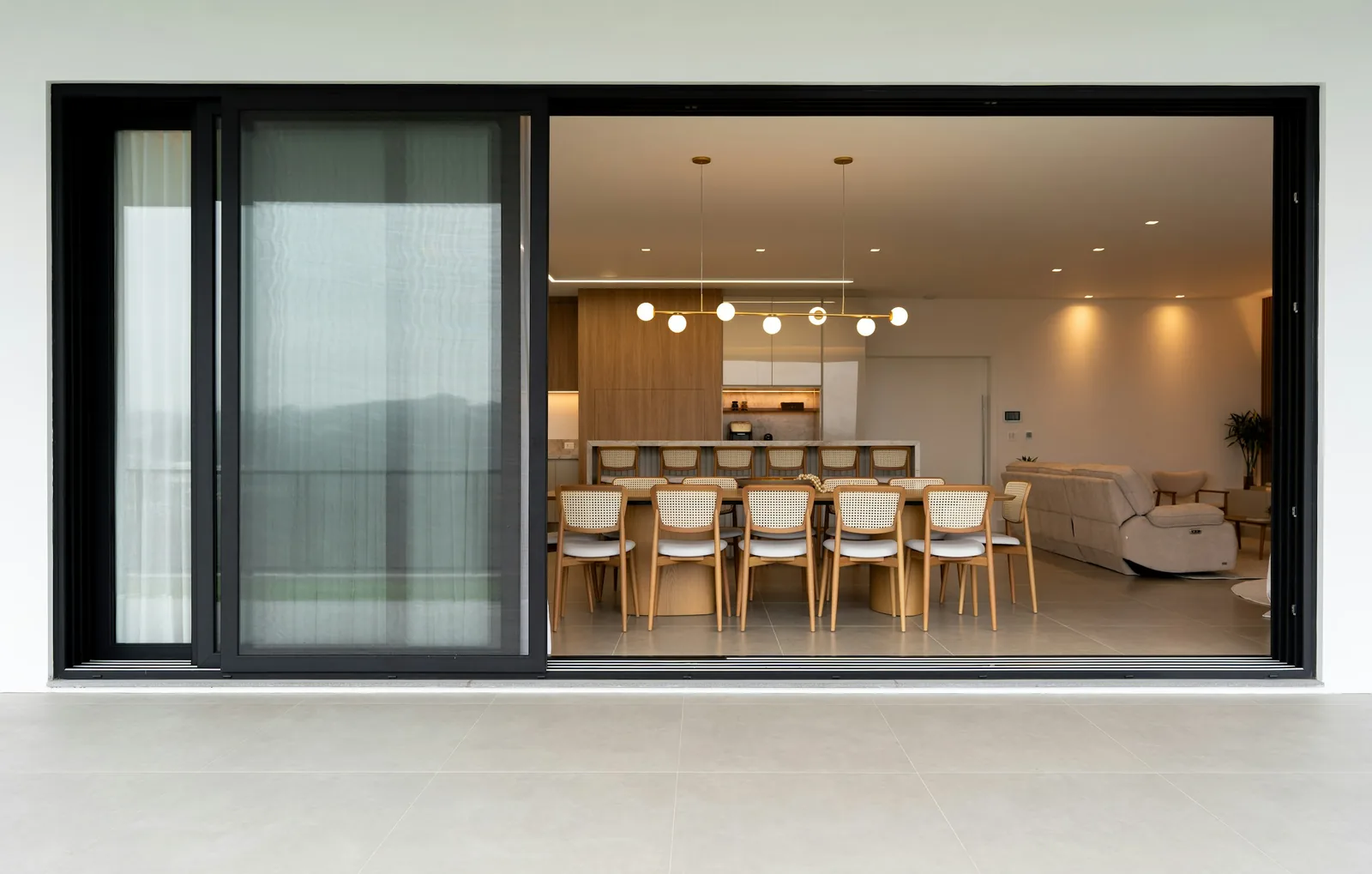 A dining room with chairs around a table.