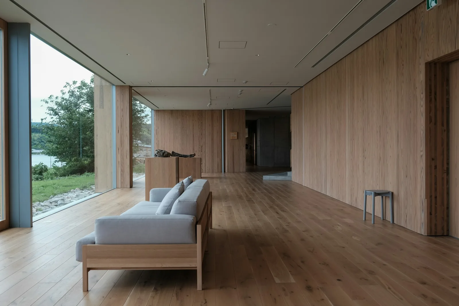 A pale sofa on a wooden floor.