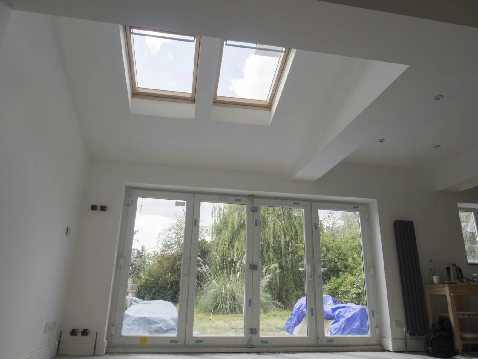 Two roof lights punched into the sloped ceiling, with downlights set in the flat section beyond.