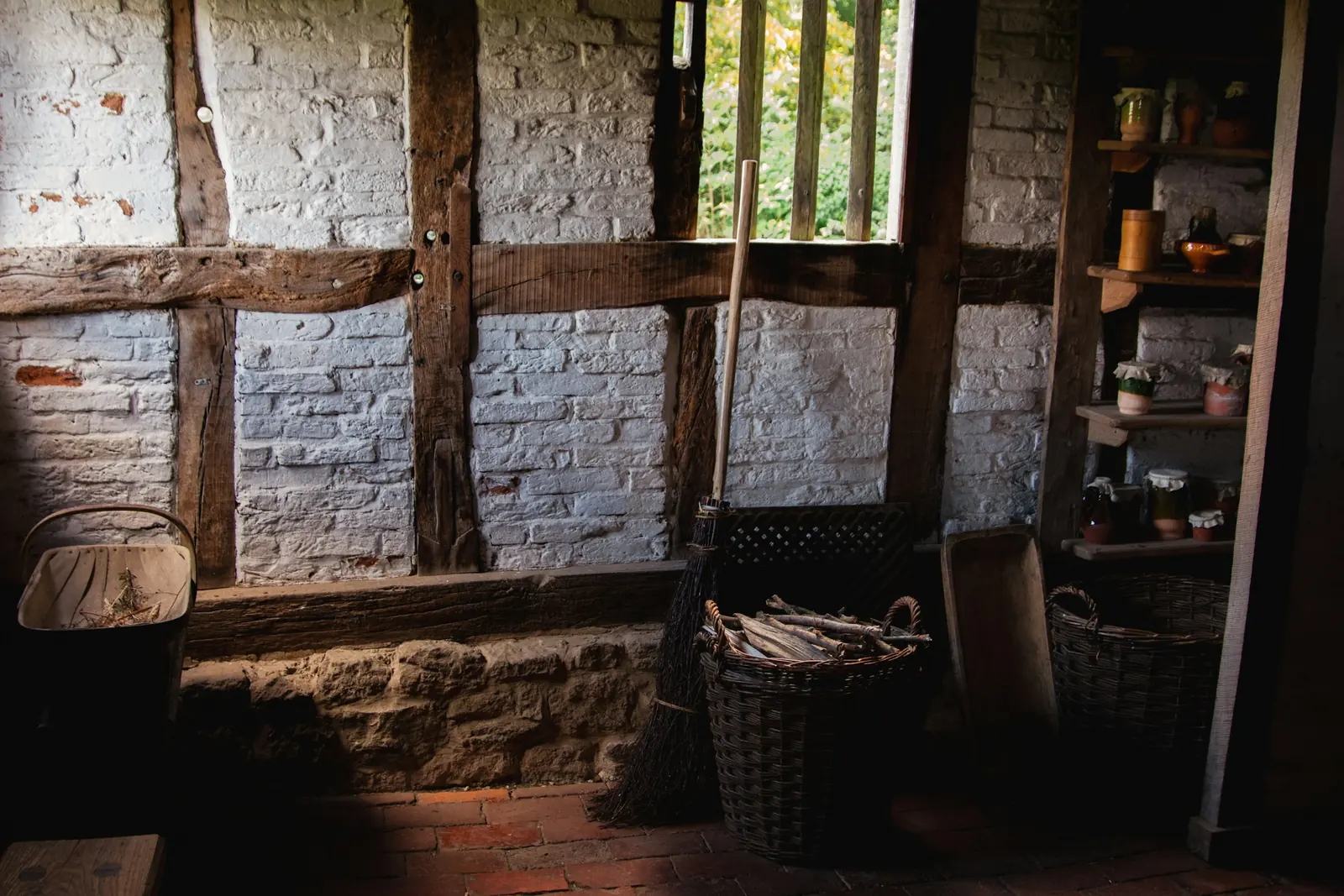 A room with an exposed brick wall and a window.