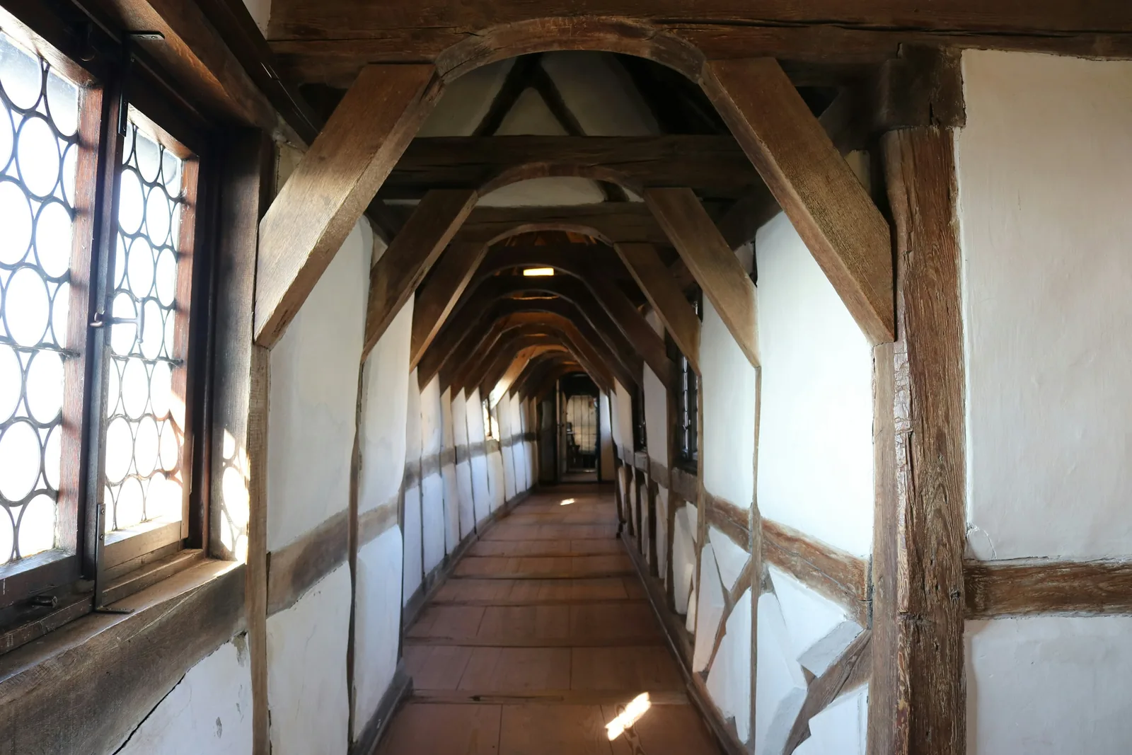A long hallway under exposed timber beams.