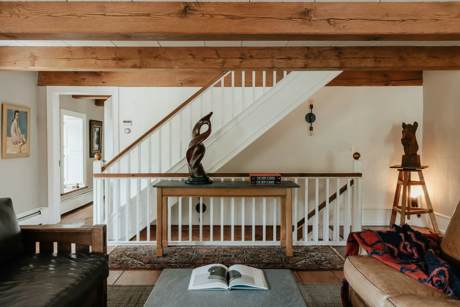 A living room with a staircase and period detailing.