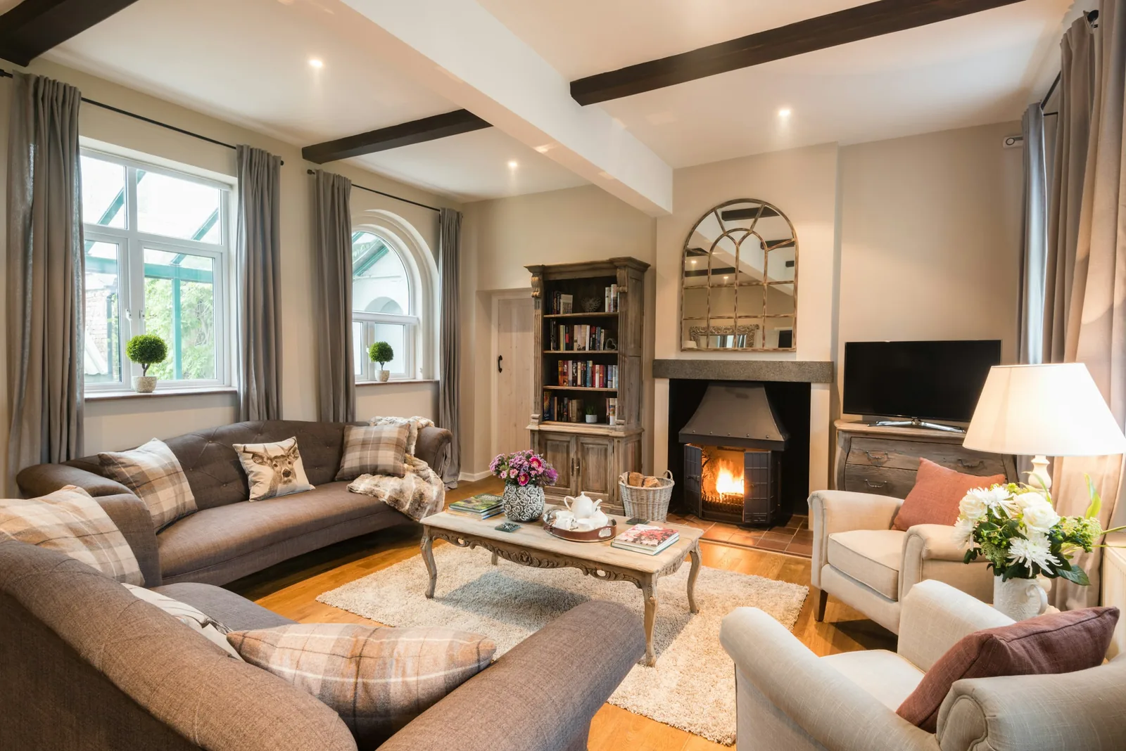 A living room with a fireplace in a period house.