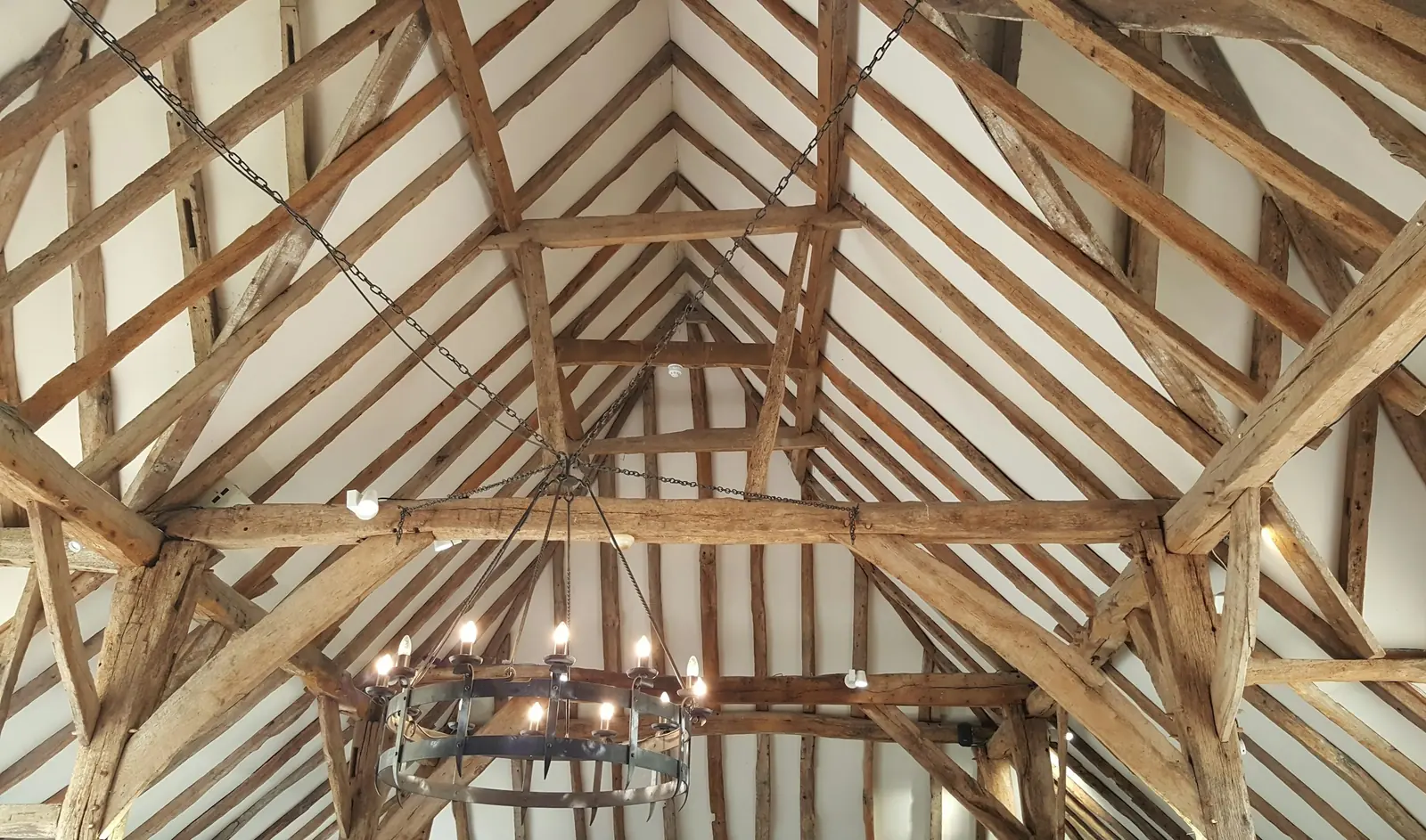 Exposed timber roof trusses in an old building.