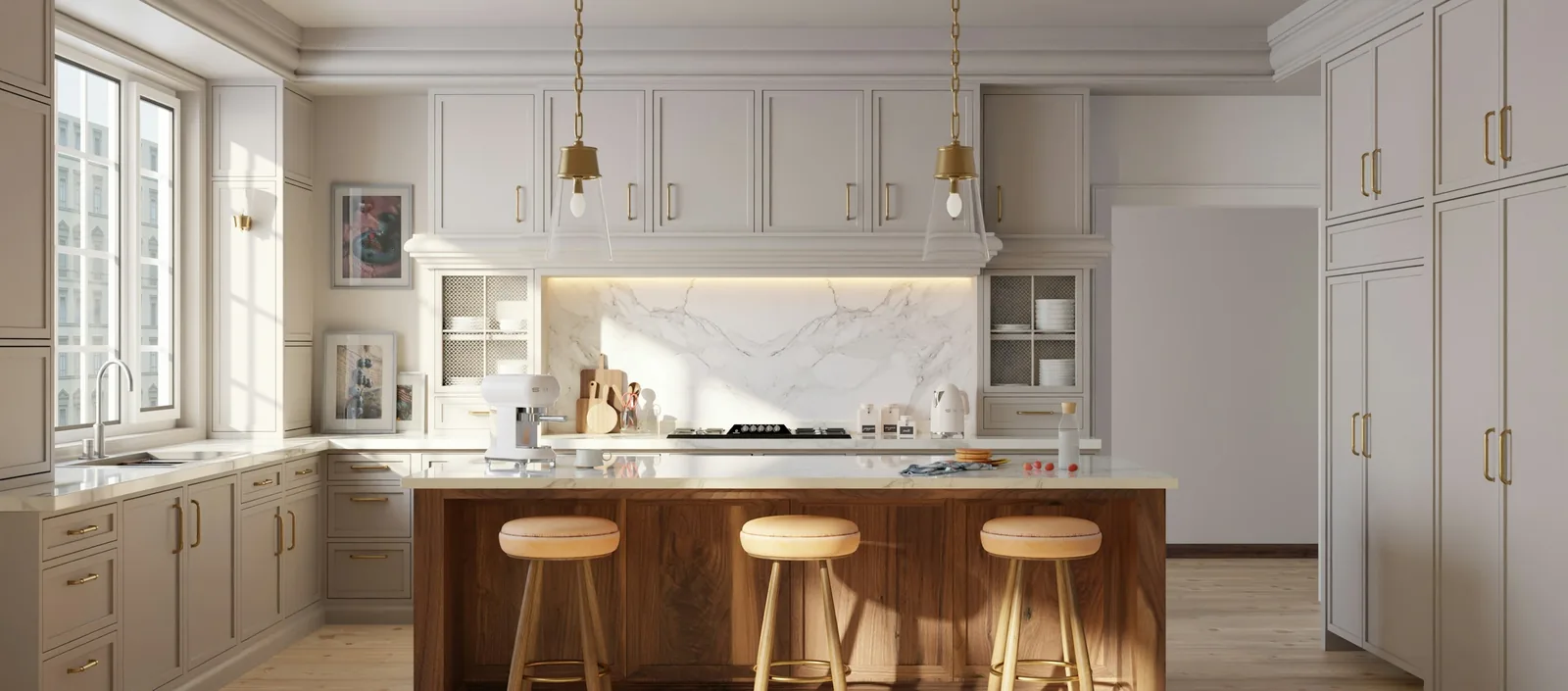 A kitchen island with three stools under pendant lighting.