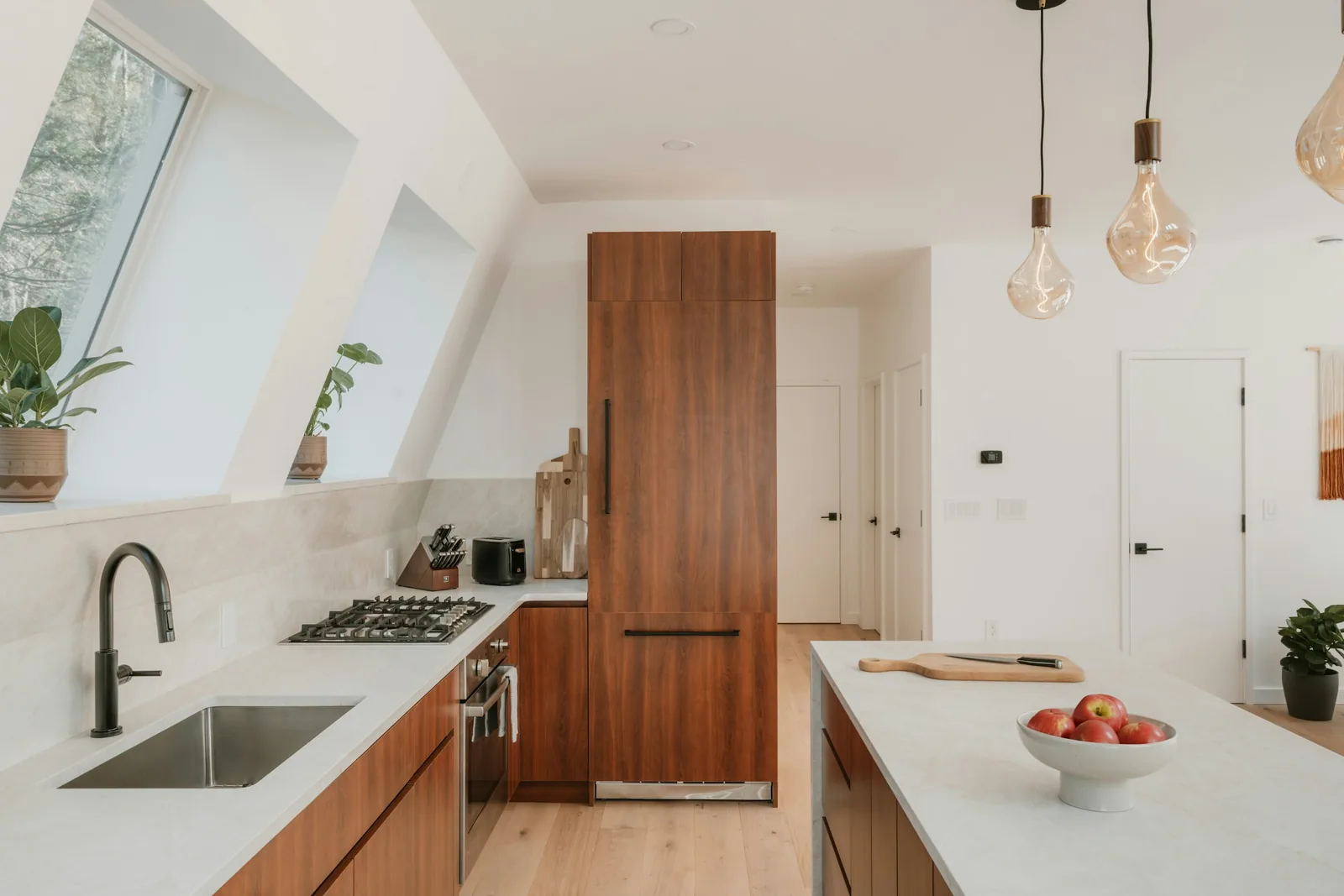 A kitchen with timber cabinets and a large island.