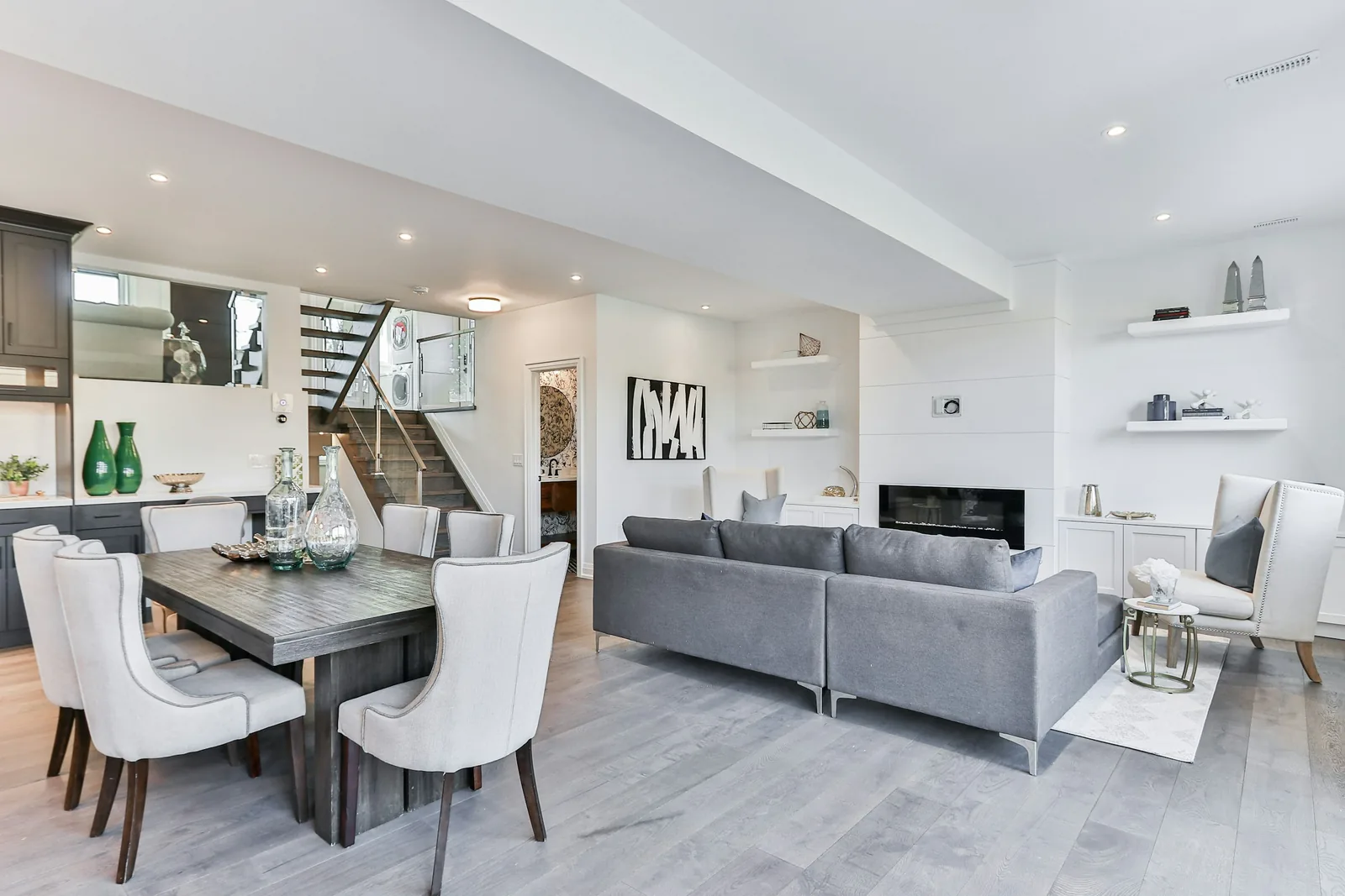 A dining table and sofa in an open-plan living room.