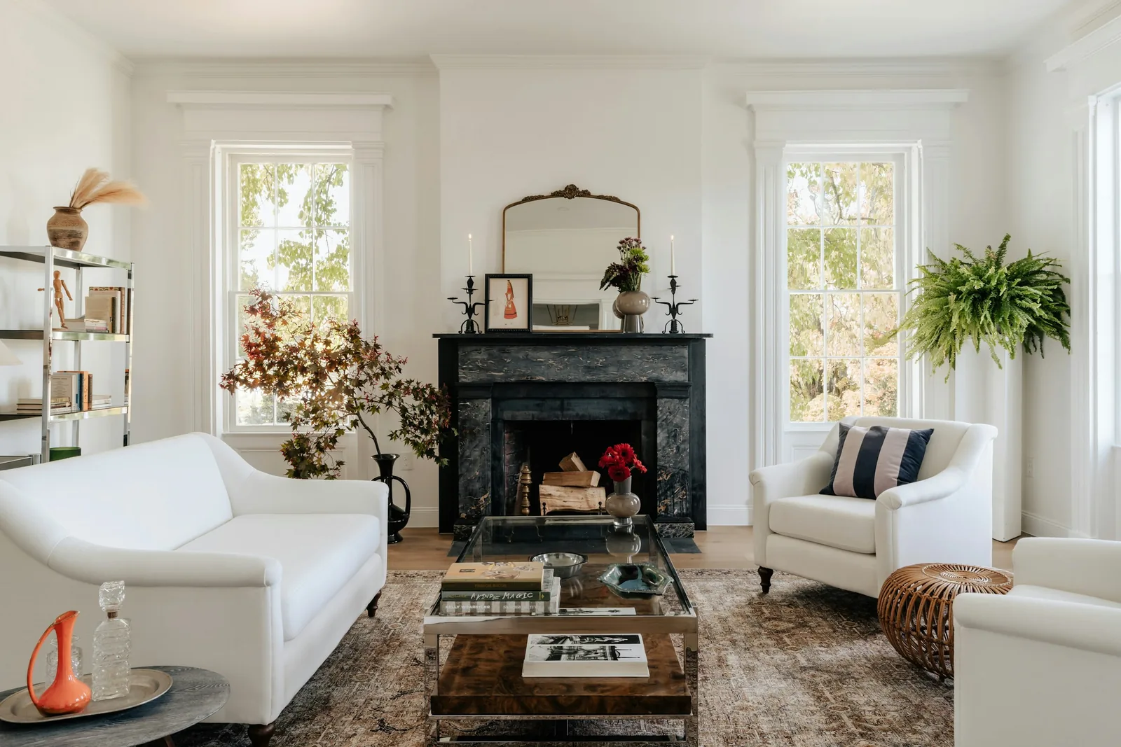 A living room with a fireplace and furniture in place.